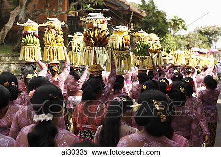 Rear view of women carrying platters of fruit on their heads during a procession, Indonesia, Bali View Large Photo Image Stock Photography - Rear view of women carrying platters of fruit on their heads during a procession, Indonesia, Bali. Fotosearch