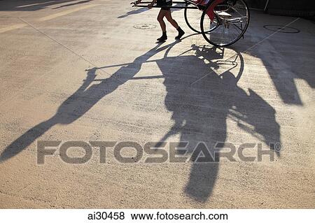 Shadow of a man pulling a rickshaw, Japan View Large Photo Image Stock Photo - Shadow of a man pulling a rickshaw, Japan. Fotosearch