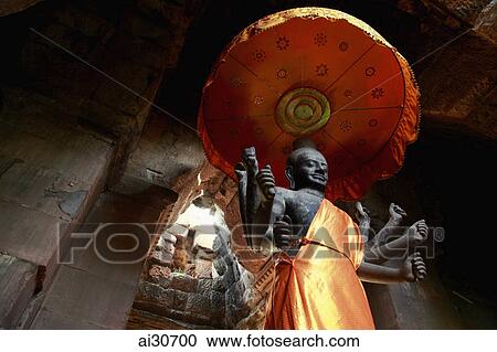 Stone Buddha draped in a gold robe inside a temple, Angkor Wat, Cambodia View Large Photo Image Stock Image - Stone Buddha draped in a gold robe inside a temple, Angkor Wat, Cambodia. Fotosearch