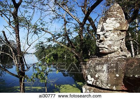 Stone carving of deity near lake, Angkor Wat, Cambodia View Large Photo Image Stock Photo - Stone carving of deity near lake, Angkor Wat, Cambodia. Fotosearch
