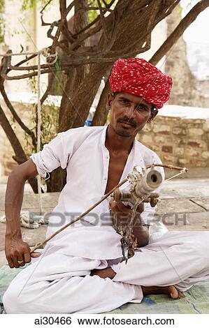 Street performer playing music at Mehrangarh Fort, Jodhpur, India View Large Photo Image Stock Photograph - Street performer playing music at Mehrangarh Fort, Jodhpur, India. Fotosearch