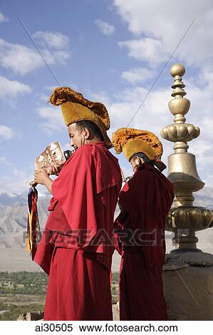 Tibetan Monks blowing horns on the rooftop of Likir Monastery in Leh, Ladakh, India View Large Photo Image Stock Photography - Tibetan Monks blowing horns on the rooftop of Likir Monastery in Leh, Ladakh, India. Fotosearch