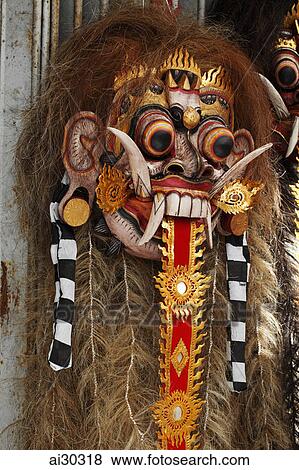 Traditional Balinese wooden mask hanging in a market. Indonesia, Bali View Large Photo Image Stock Photo - Traditional Balinese wooden mask hanging in a market. Indonesia, Bali. Fotosearch