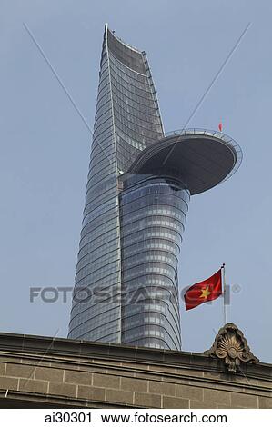 Vietnamese flag on top of older building with Bitexco Financial Tower in the background. Ho Chi Minh, Vietnam View Large Photo Image Stock Image - Vietnamese flag on top of older building with Bitexco Financial Tower in the background. Ho Chi Minh, Vietnam. Fotosearch