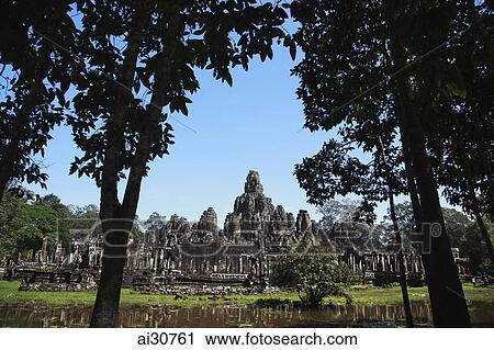 View of Bayon Temple through trees, Angkor Wat, Cambodia View Large Photo Image Stock Image - View of Bayon Temple through trees, Angkor Wat, Cambodia. Fotosearch