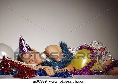 Woman asleep among party balloons and streamers View Large Photo Image Stock Photo - Woman asleep among party balloons and streamers. Fotosearch