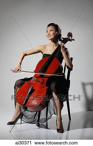 Woman dressed elegantly and playing the Cello View Large Photo Image Stock Image - Woman dressed elegantly and playing the Cello. Fotosearch