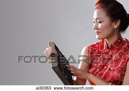 Woman wearing Cheongsam and holding an abacus View Large Photo Image Stock Image - Woman wearing Cheongsam and holding an abacus. Fotosearch