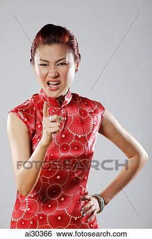 Woman wearing Cheongsam looking angry and pointing finger View Large Photo Image Stock Photograph - Woman wearing Cheongsam looking angry and pointing finger. Fotosearch