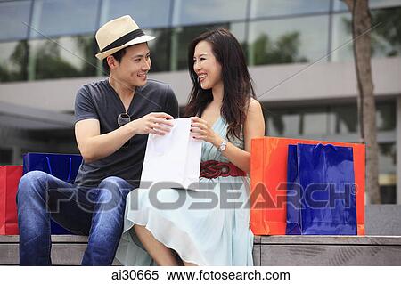 Young couple with shopping bags View Large Photo Image Stock Photography - Young couple with shopping bags. Fotosearch