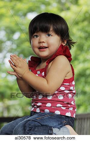 Young girl clapping her hands and smiling View Large Photo Image Stock Photo - Young girl clapping her hands and smiling. Fotosearch