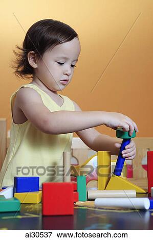 Stock Photo - Young girl playing with blocks. Fotosearch