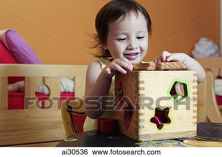 Young girl playing with blocks View Large Photo Image Stock Photograph - Young girl playing with blocks. Fotosearch