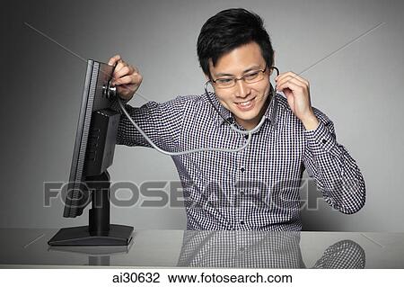 Young man listening to computer with stethoscope. View Large Photo Image Stock Image - Young man listening to computer with stethoscope.. Fotosearch