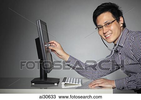 Young man listening to computer with stethoscope. View Large Photo Image Stock Image - Young man listening to computer with stethoscope.. Fotosearch