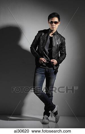 Stock Image - Young man wearing sunglasses and leather jacket.. Fotosearch