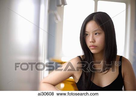 Young woman looking out the window View Large Photo Image Stock Photo - Young woman looking out the window. Fotosearch