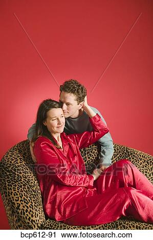 Affectionate couple on leopard print couch View Large Photo Image Stock Image - Affectionate couple on leopard print couch. Fotosearch