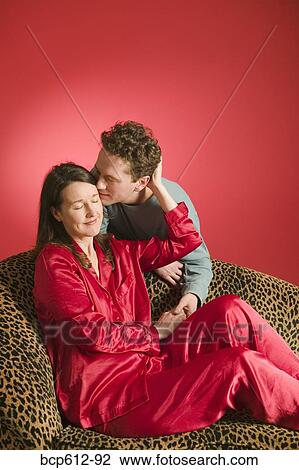 Affectionate couple on leopard print couch View Large Photo Image Stock Image - Affectionate couple on leopard print couch. Fotosearch