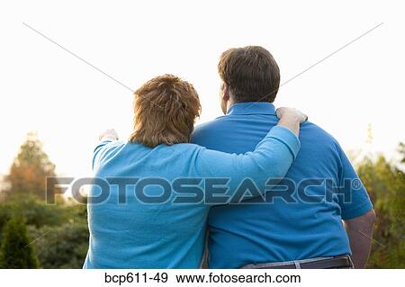 Backside of couple looking at view View Large Photo Image Stock Photo - Backside of couple looking at view. Fotosearch