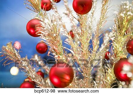 Stock Photo - Closeup of fake Christmas tree with ornaments. Fotosearch