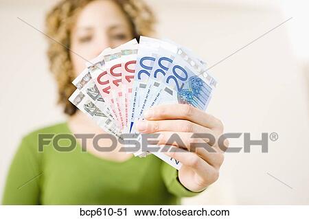 Closeup of woman holding Euros View Large Photo Image Stock Image - Closeup of woman holding Euros. Fotosearch