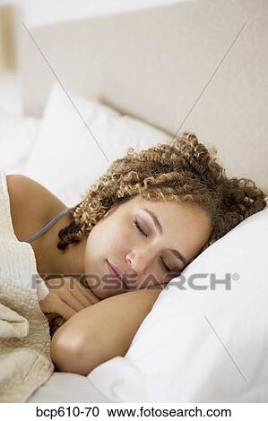 Stock Image - Closeup of woman sleeping peacefully. Fotosearch