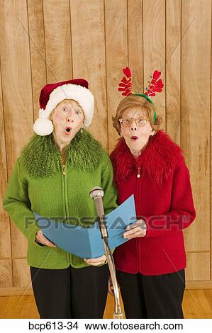 Elderly women singing at Christmastime View Large Photo Image Picture - Elderly women singing at Christmastime. Fotosearch