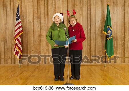Stock Photograph - Elderly women singing at Christmastime. Fotosearch
