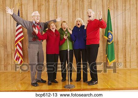 Enthusiastic elderly people singing on stage View Large Photo Image Stock Image - Enthusiastic elderly people singing on stage. Fotosearch