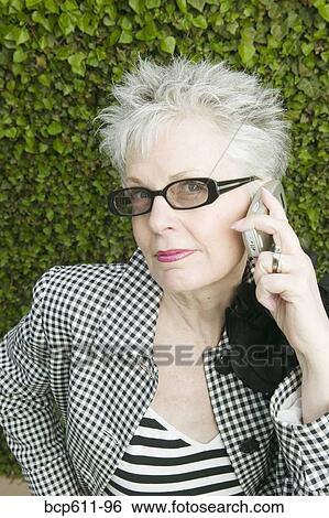 Fashionable woman using mobile phone View Large Photo Image Stock Photograph - Fashionable woman using mobile phone. Fotosearch