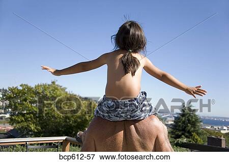 Father carrying daughter on shoulders View Large Photo Image Stock Photo - Father carrying daughter on shoulders. Fotosearch