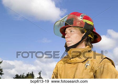 Stock Photo - Female firefighter in uniform outside. Fotosearch