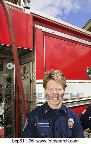 Female firefighter with fire truck View Large Photo Image Stock Photograph - Female firefighter with fire truck. Fotosearch