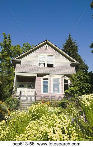 Stock Photograph - Front of duplex with trees and gardens. Fotosearch