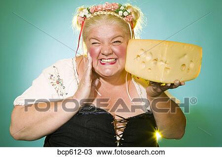 Germanic woman posing with cheese wedge View Large Photo Image Stock Image - Germanic woman posing with cheese wedge. Fotosearch