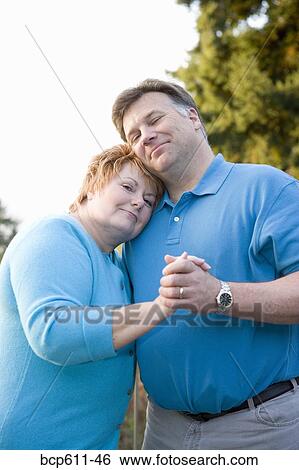 Happy middle aged couple dancing outside View Large Photo Image Stock Photograph - Happy middle aged couple dancing outside. Fotosearch