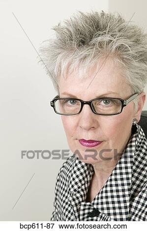 Headshot of middle aged woman with glasses View Large Photo Image Stock Photo - Headshot of middle aged woman with glasses. Fotosearch