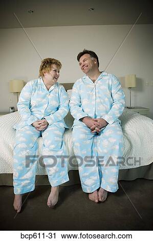 Laughing couple in matching pajamas View Large Photo Image Stock Image - Laughing couple in matching pajamas. Fotosearch