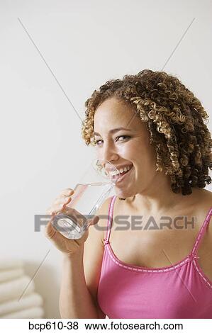 Laughing woman with glass of water View Large Photo Image Stock Photo - Laughing woman with glass of water. Fotosearch