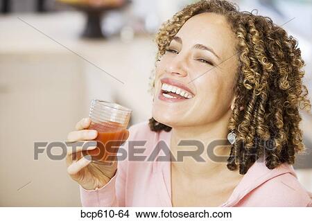 Laughing woman with tomato juice View Large Photo Image Picture - Laughing woman with tomato juice. Fotosearch