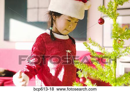 Little girl with Christmas tree View Large Photo Image Stock Photo - Little girl with Christmas tree. Fotosearch