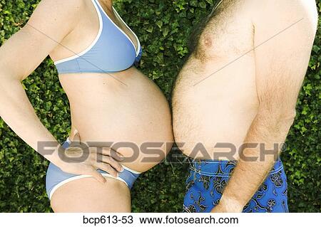 Man and pregnant woman touching bellies View Large Photo Image Stock Image - Man and pregnant woman touching bellies. Fotosearch