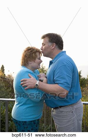 Man kissing wife on balcony View Large Photo Image Stock Image - Man kissing wife on balcony. Fotosearch