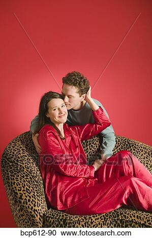 Man kissing woman on leopard print couch View Large Photo Image Stock Image - Man kissing woman on leopard print couch. Fotosearch