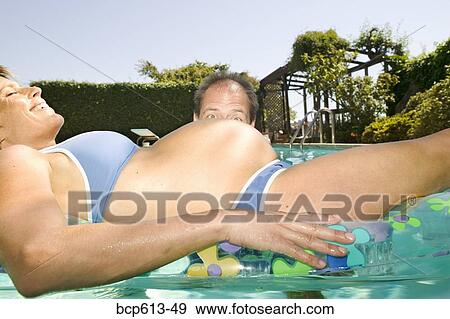 Man peeking at floating pregnant woman View Large Photo Image Stock Photo - Man peeking at floating pregnant woman. Fotosearch