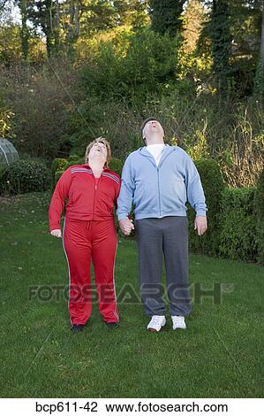 Middle aged couple in yard looking up View Large Photo Image Stock Image - Middle aged couple in yard looking up. Fotosearch
