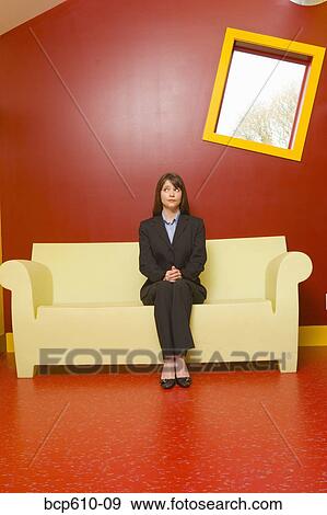 Nervous businesswoman waiting in red room View Large Photo Image Stock Photo - Nervous businesswoman waiting in red room. Fotosearch