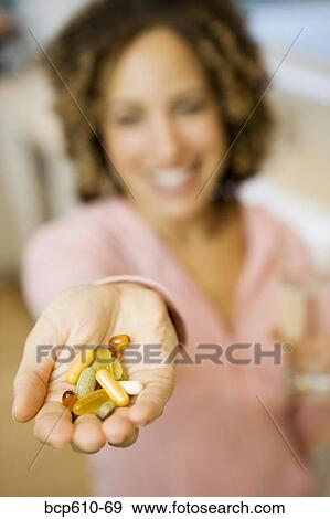 Pills in female outstretched palm View Large Photo Image Stock Photo - Pills in female outstretched palm. Fotosearch