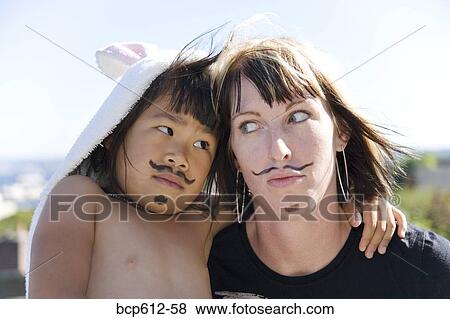 Playful woman and girl with painted mustaches View Large Photo Image Stock Photo - Playful woman and girl with painted mustaches. Fotosearch